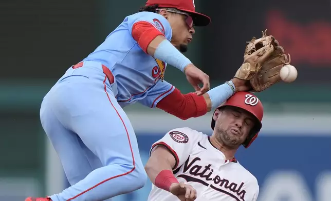 Washington Nationals' Lane Thomas, right, collides with St. Louis Cardinals shortstop Masyn Winn, left, while stealing second base during the first inning of a baseball game at Nationals Park, Saturday, July 6, 2024, in Washington. The Nationals beat the Cardinals, 14-6. (AP Photo/Mark Schiefelbein)