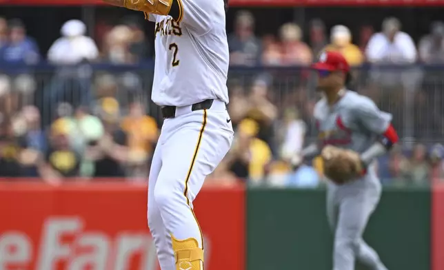 Pittsburgh Pirates' Connor Joe reacts at second base after hitting a two-run RBI double during the second inning of a baseball game against the St. Louis Cardinals in Pittsburgh, Wednesday, July 24, 2024. (AP Photo/Justin Berl)