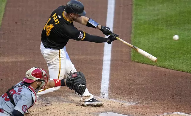 Pittsburgh Pirates' Joey Bart (14) hits a sacrifice fly off off St. Louis Cardinals starting pitcher Miles Mikolas, driving in a run, during the fifth inning of a baseball game in Pittsburgh, Wednesday, July 3, 2024. (AP Photo/Gene J. Puskar)