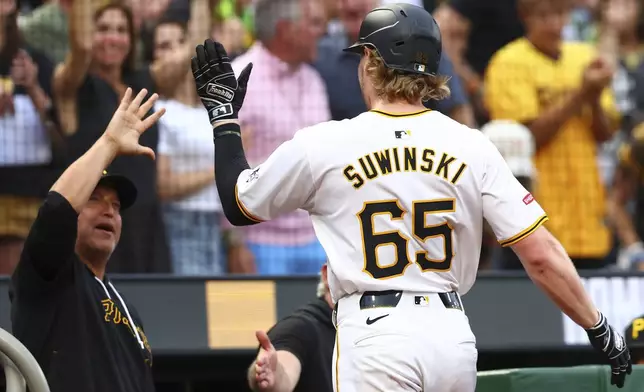 Pittsburgh Pirates Jack Suwinski (65) reacts after hitting a three-run home run against the St. Louis Cardinals during a baseball game in Pittsburgh, Tuesday, July 2, 2024. (AP Photo/Jared Wickerham)