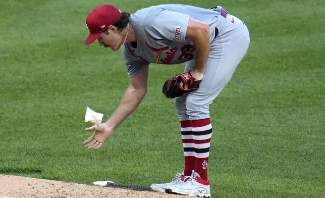 St. Louis Cardinals starting pitcher Miles Mikolas tosses the rosin bag on the mound during the fifth inning of a baseball game against the Pittsburgh Pirates in Pittsburgh, Wednesday, July 3, 2024. (AP Photo/Gene J. Puskar)
