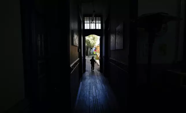 Sebastian, the son of Venezuelan migrant couple Karen Salazar and Luis Henrique, runs inside the shelter "Nuestra Casa" or Our Home in the Yungay neighborhood of Santiago, Chile, Thursday, May 30, 2024. After fleeing Venezuela and finding life as a migrant intolerable in Colombia and then Ecuador, Sebastian's family migrated to Chile. (AP Photo/Esteban Felix)