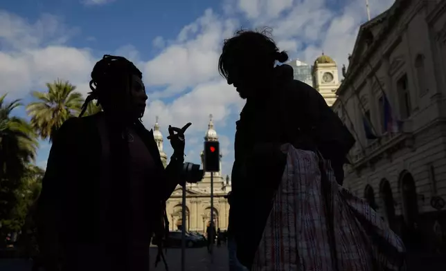 Homeless person Paris Lopez, right, talks with a member of the NGO Diverse Action before they meet with a city council member in Santiago, Chile, Monday, April 29, 2024. Lopez, a Chilean trans woman, is meeting with the city worker to complain that police confiscate her tent and blankets, as well as her HIV medication, while she sleeps in public spaces. (AP Photo/Esteban Felix)