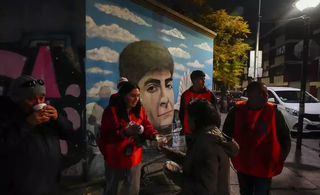 Volunteers from the Nuestra Casa shelter hand out sandwiches and tea to the homeless in the Yungay neighborhood of Santiago, Chile, June 6, 2024. Over the last four years, the rate of homelessness in one of South America's richest economies has jumped more than 30%. (AP Photo/Esteban Felix)