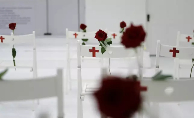 FILE - In this Nov. 12, 2017, file photo, a memorial for the victims of the shooting at Sutherland Springs First Baptist Church, including 26 white chairs each painted with a cross and and rose, is displayed in the church in Sutherland Springs, Texas. (AP Photo/Eric Gay, File)