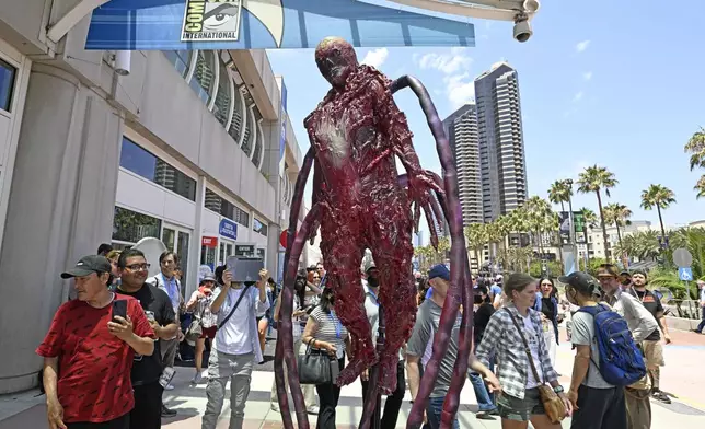 FILE - A robotic creature rolls in front of the convention center on day three of Comic-Con International on Saturday, July 23, 2022, in San Diego. The comic book and pop culture extravaganza, which draws over 130,000 fans annually, opens for a preview night Wednesday and runs from Thursday through Sunday. (Photo by Denis Poroy/Invision/AP, File)