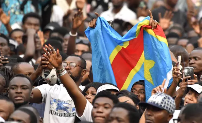 People attend a music concert at the Stade des Martyrs of Kinshasa, Democratic Republic of Congo, Saturday, July 27, 2024. Multiple people were killed and many others were injured during a stampede at the concert, according to authorities. (AP Photo/Samy Ntumba Shambuyi)