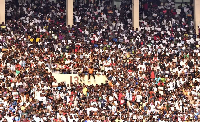 People attend a music concert at Stade des Martyrs of Kinshasa, Democratic Republic of Congo, Saturday, July 27, 2024. Multiple people were killed and many others were injured during a stampede at the concert, according to authorities. (AP Photo/Samy Ntumba Shambuyi)