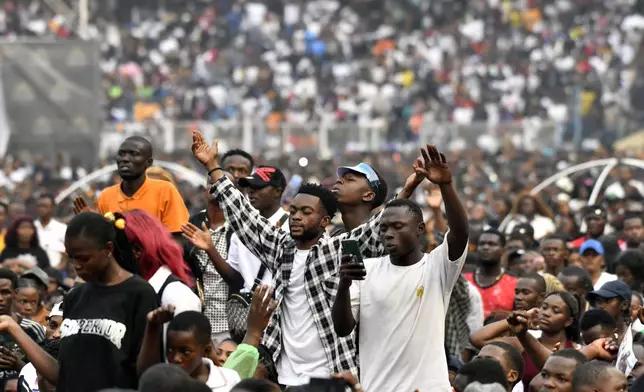 People attend a music concert at the Stade des Martyrs of Kinshasa, Democratic Republic of Congo, Saturday, July 27, 2024. Multiple people were killed and many others were injured during a stampede at the concert, according to authorities. (AP Photo/Samy Ntumba Shambuyi)