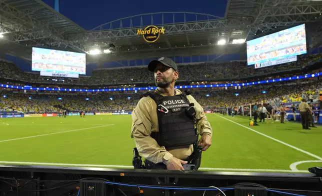 A police officer stands on the field prior to the Copa America final soccer match between Argentina and Colombia in Miami Gardens, Fla., Sunday, July 14, 2024. (AP Photo/Rebecca Blackwell)