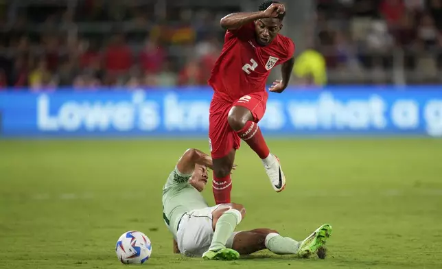 Panama's Cesar Blackman, top, is tackled by Bolivia's Jose Sagredo during a Copa America Group C soccer match in Orlando, Fla., Monday, July 1, 2024. (AP Photo/John Raoux)
