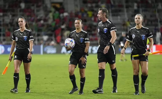 Referees Mary Blanco from Colombia, Edina Alves Batista, second from left, Raphael Claus and Neuza Bak from Brazil walk off the field at half time during a Copa America Group C soccer match in Orlando, Fla., Monday, July 1, 2024. (AP Photo/John Raoux)