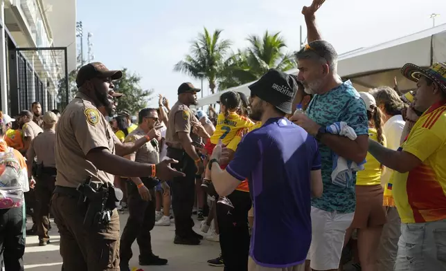 Police talk with fans outside the stadium prior to the Copa America final soccer match between Argentina and Colombia in Miami Gardens, Fla., Sunday, July 14, 2024. (AP Photo/Lynne Sladky)