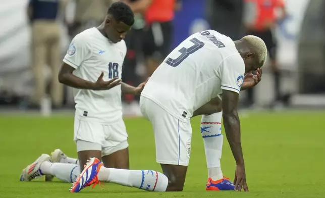 Panama's Jose Cordoba (3) and teammate Omar Valencia kneel after their 0-5 lost against Colombia in a Copa America quarterfinal soccer match in Glendale, Ariz., Saturday, July 6, 2024. (AP Photo/Ross Franklin)