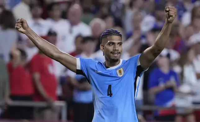 Uruguay's Ronald Araujo celebrates after his team defeated the United States in an Copa America Group C soccer match, Monday, July 1, 2024, in Kansas City, Mo. (AP Photo/Ed Zurga)