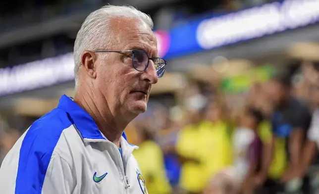 Brazil's coach Dorival Junior walks off the field after his team's lost against Uruguay during a Copa America quarterfinal soccer match in Las Vegas, Saturday, July 6, 2024. (AP Photo/Julio Cortez)