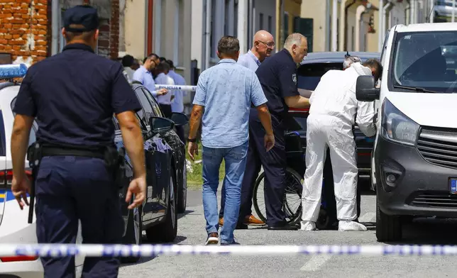 Police and forensics gather near the crime scene in Daruvar, central Croatia, Monday, July 22, 2024. An armed assailant entered a care home for older people in central Croatia Monday and opened fire, killing five people and wounding several others, authorities and media reports said. (Zeljko Puhovski/Cropix via AP)