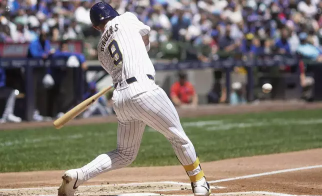Milwaukee Brewers' Jake Bauers hits a single during the second inning of a baseball game against the Chicago Cubs Sunday, June 30, 2024, in Milwaukee. (AP Photo/Morry Gash)