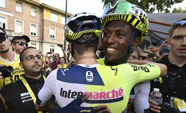 Stage winner Eritrea's Biniam Girmay celebrates with a teammate after during the third stage of the Tour de France cycling race over 230.8 kilometers (143.4 miles) with start in Plaisance and finish in Turin, Italy, Monday, July 1, 2024. (Tim de Waele/Pool Photo via AP)