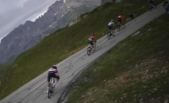 A breakaway group rides in the descent of the Col du Galibier during the fourth stage of the Tour de France cycling race over 139.6 kilometers (86.7 miles) with start in Pinerolo, Italy and finish in Valloire, France, Tuesday, July 2, 2024. (AP Photo/Daniel Cole)