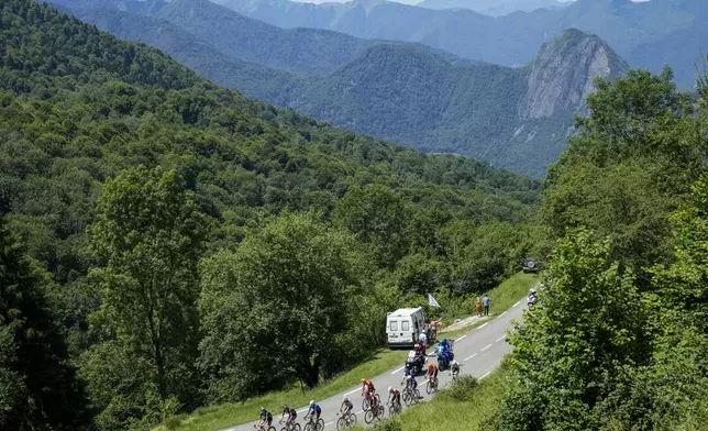 The breakaway group climbs during the fifteenth stage of the Tour de France cycling race over 198 kilometers (123 miles) with start in Loudenvielle and finish on Plateau de Beille, France, Sunday, July 14, 2024. (AP Photo/Jerome Delay)