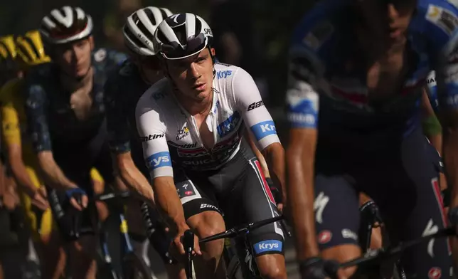 Belgium's Remco Evenepoel, wearing the best young rider's white jersey, rides in the group yellow jersey as they climb during the twentieth stage of the Tour de France cycling race over 132.8 kilometers (82.5 miles) with start in Nice and finish in La Couillole pass, France, Saturday, July 20, 2024. (AP Photo/Daniel Cole)