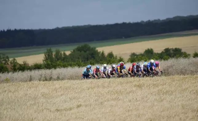 The breakaway group rides in the heat during the ninth stage of the Tour de France cycling race over 199 kilometers (123.7 miles) with start and finish in Troyes, France, Sunday, July 7, 2024. (AP Photo/Jerome Delay)