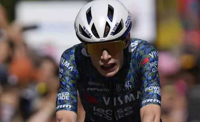 Denmark's Jonas Vingegaard reacts as he crosses the finish line of the fourth stage of the Tour de France cycling race over 139.6 kilometers (86.7 miles) with start in Pinerolo, Italy and finish in Valloire, France, Tuesday, July 2, 2024. (AP Photo/Jerome Delay)