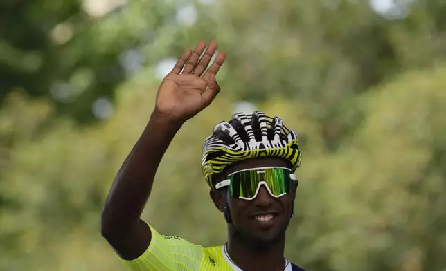 Eritrea's Biniam Girmay greets spectators prior to the first stage of the Tour de France cycling race over 206 kilometers (128 miles) with start in Florence and finish in Rimini, Italy, Saturday, June 29, 2024. (AP Photo/Jerome Delay)