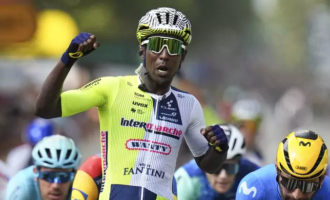 Eritrea's Biniam Girmay celebrates winning ahead of Colombia's Fernado Gavira, right, during the third stage of the Tour de France cycling race over 230.8 kilometers (143.4 miles) with start in Piacenza and finish in Turin, Italy, Monday, July 1, 2024. (AP Photo/Daniel Cole)