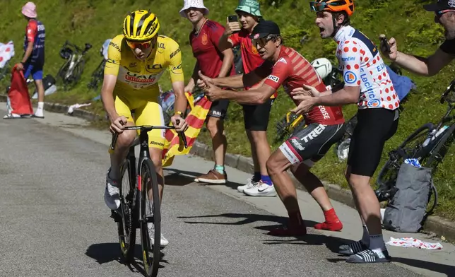 Stage winner Slovenia's Tadej Pogacar, wearing the overall leader's yellow jersey, climbs towards Plateau de Beille during the fifteenth stage of the Tour de France cycling race over 198 kilometers (123 miles) with start in Loudenvielle and finish on Plateau de Beille, France, Sunday, July 14, 2024. (AP Photo/Jerome Delay)