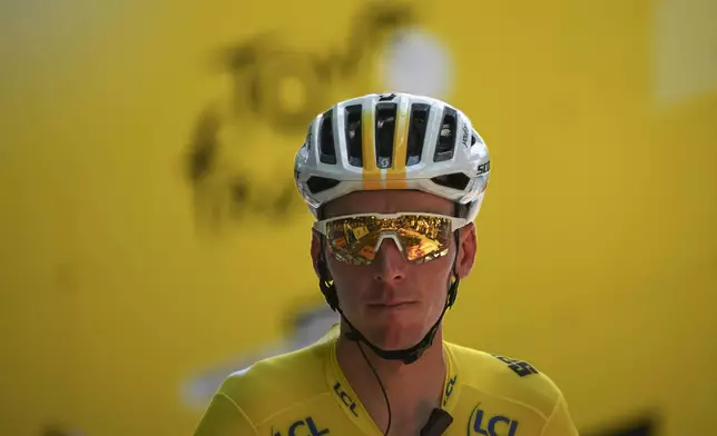 France's Romain Bardet, wearing the overall leader's yellow jersey, waits for the start of the second stage of the Tour de France cycling race over 199.2 kilometers (123.8 miles) with start in Cesenatico and finish in Bologna, Italy, Sunday, June 30, 2024. (AP Photo/Daniel Cole)