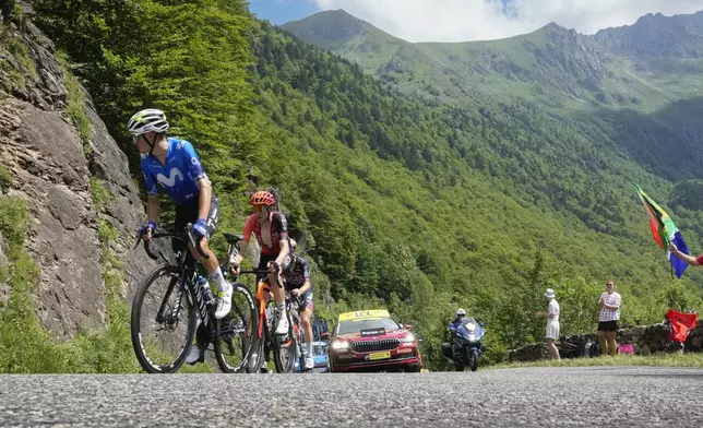 Spain's Enric Mas leads the breakaway followed by Belgium's Laurens de Plus and Australia's Jai Hindley during the fifteenth stage of the Tour de France cycling race over 198 kilometers (123 miles) with start in Loudenvielle and finish on Plateau de Beille, France, Sunday, July 14, 2024. (AP Photo/Jerome Delay)