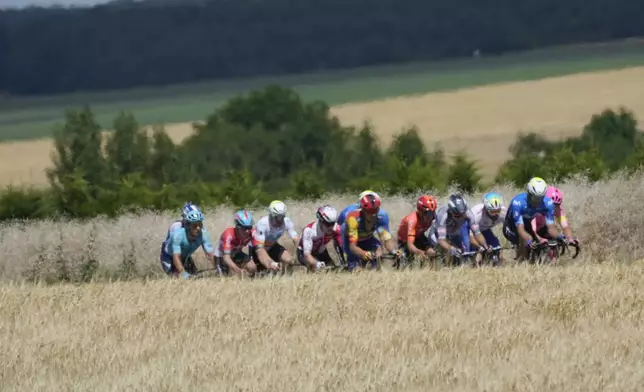 Heat haze blurs the rides of the breakaway group during the ninth stage of the Tour de France cycling race over 199 kilometers (123.7 miles) with start and finish in Troyes, France, Sunday, July 7, 2024. (AP Photo/Jerome Delay)