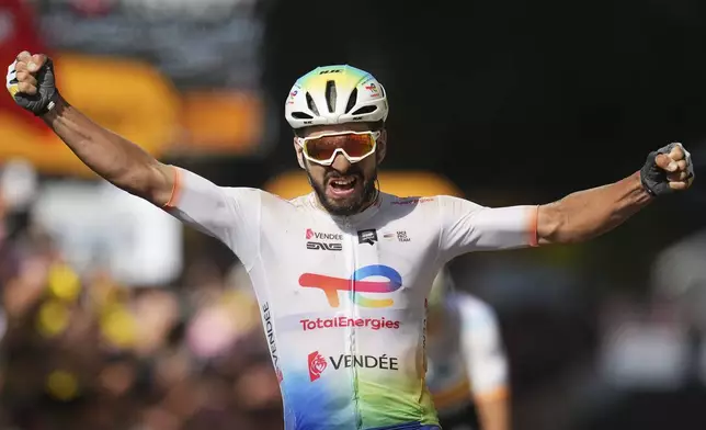 France's Anthony Turgis crosses the finish line to win the ninth stage of the Tour de France cycling race over 199 kilometers (123.7 miles) with start and finish in Troyes, France, Sunday, July 7, 2024. (AP Photo/Daniel Cole)