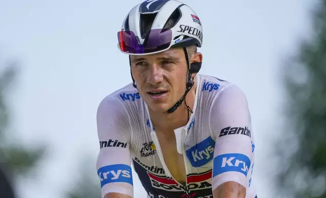 Belgium's Remco Evenepoel, wearing the best young rider's white jersey, strains as he crosses the finish line of the twentieth stage of the Tour de France cycling race over 132.8 kilometers (82.5 miles) with start in Nice and finish in La Couillole pass, France, Saturday, July 20, 2024. (AP Photo/Jerome Delay)