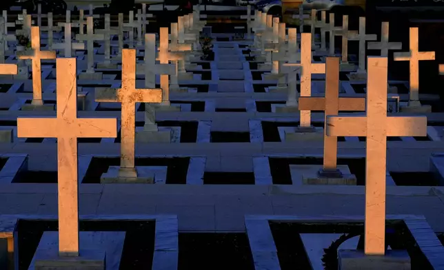 Graves of Greek and Greek Cypriot soldiers who were killed on 1974 during the Turkish invasion, at the military cemetery in the divided capital Nicosia, Cyprus, Friday, July 19, 2024. Saturday marks the 50th anniversary of Cyprus' ethnic division after Turkish invaded in the summer of 1974 in the wake of an Athens junta-backed coup aiming at union with Greece. (AP Photo/Petros Karadjias)