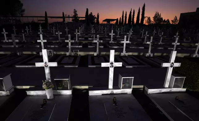 Graves of Greek and Greek Cypriot soldiers who were killed on 1974 during the Turkish invasion, are seen at the military cemetery in the divided capital Nicosia, Cyprus, Friday, July 19, 2024. Saturday marks the 50th anniversary of Cyprus' ethnic division after Turkish invaded in the summer of 1974 in the wake of an Athens junta-backed coup aiming at union with Greece. (AP Photo/Petros Karadjias)