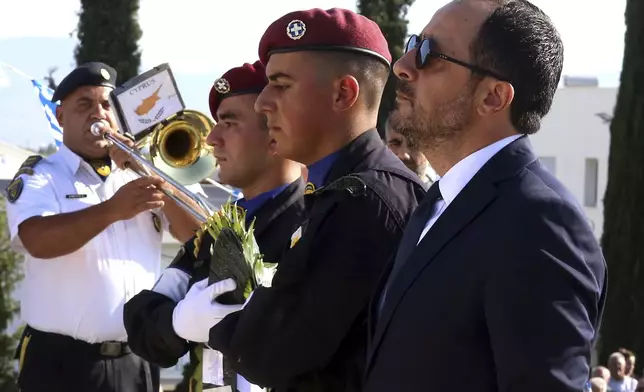 Cyprus President Nicos Christodoulides attending the memorial service for the soldiers, killed during the 1974 Turkish invasion of Cyprus, in the Tymvos Macedonitissas military cemetery during the 50th anniversary in the divided capital of Nicosia, Cyprus, Saturday, July 20, 2024. Saturday marks the 50th anniversary of Cyprus' ethnic division after Turkish invaded in the summer of 1974 in the wake of an Athens junta-backed coup aiming at union with Greece. (AP Photo/Philippos Christou)