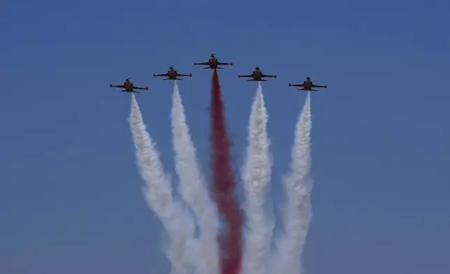 Turkey's acrobatic aircrafts fly over the military parade, in the Turkish occupied area of the divided capital Nicosia, Cyprus, Saturday, July 20, 2024. (AP Photo/Petros Karadjias)