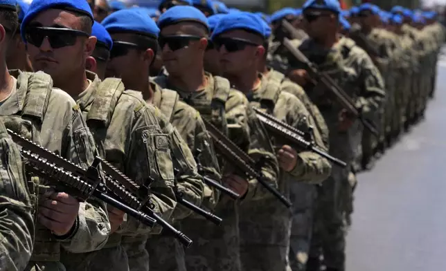 Turkish soldiers take part in a military parade, in the Turkish occupied area of the divided capital Nicosia, Cyprus, Saturday, July 20, 2024. (AP Photo/Petros Karadjias)