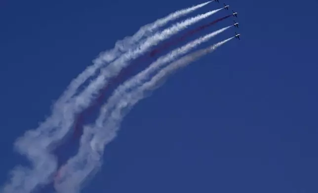 Turkey's acrobatic aircrafts fly over the military parade, in the Turkish occupied area of the divided capital Nicosia, Cyprus, Saturday, July 20, 2024. (AP Photo/Petros Karadjias)