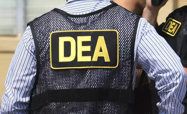 FILE - This June 13, 2016 photo shows Drug Enforcement Administration agents in Florida. Thousands of secret law enforcement documents offer a never-before-seen window into a rape case and a culture of corruption among federal narcotics agents who parlayed the DEA’s shadowy money laundering operations into a worldwide pursuit of binge drinking and illicit sex. (Joe Burbank/Orlando Sentinel via AP, File)