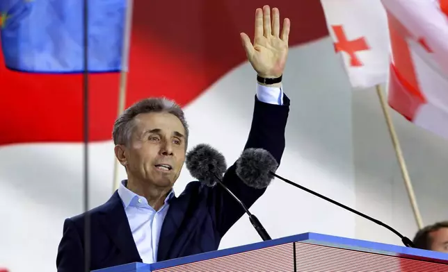 FILE Billionaire Bidzina Ivanishvili, leader of the created by him the Georgian Dream party greets demonstrators during a rally in support of "Russian law" in Tbilisi, Georgia, on April 29, 2024, a proposed law that would require media and non-commercial organizations to register as being under foreign influence if they receive more than 20% of their funding from abroad. Ivanishvili, a former prime minister, made his fortune in Russia. His Georgian Dream party promised to restore civil rights, "reset" relations with Moscow and pursue membership in the European Union. It has, however, been accused of creeping authoritarianism, especially not pursuing reforms necessary to ensure juridical independence. (AP Photo/Shakh Aivazov, File)