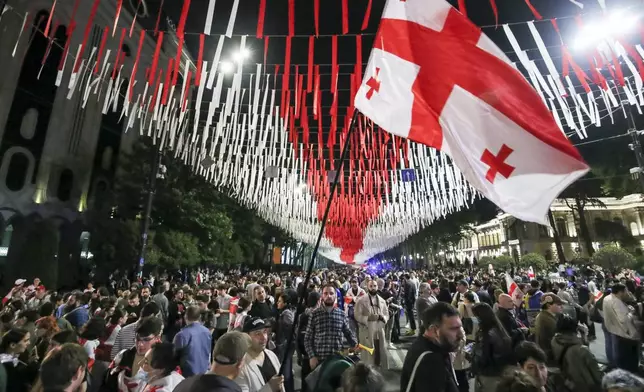 FILE Demonstrators with a Georgian national flag gather at the Parliamentary building during an opposition protest against the foreign influence bill in Tbilisi, Georgia, on May 28, 2024. Thousands of people rallied in Georgia for weeks against the foreign influence bill. Critics compared it to similar legislation Russia uses to stifle dissent, and they worried it would jeopardize Georgia's prospects of joining the European Union. (AP Photo/Zurab Tsertsvadze, File)