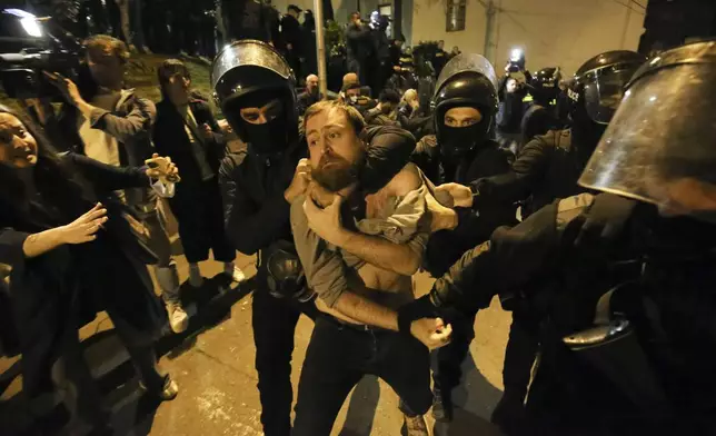 FILE Police officers detain a protestor during a demonstration outside the parliament building in Tbilisi, Georgia, on April 16, 2024, to protest against "the Russian law" similar to a law that Russia uses to stigmatize independent news media and organizations seen as being at odds with the Kremlin. Thousands of people rallied in Georgia for weeks against the foreign influence bill. Critics compared it to similar legislation Russia uses to stifle dissent, and they worried it would jeopardize Georgia's prospects of joining the European Union. (AP Photo/Zurab Tsertsvadze, File)