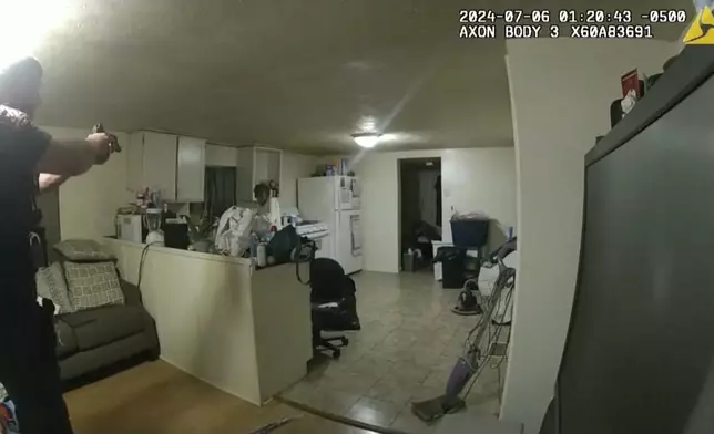 In this image taken from body camera video released by Illinois State Police on Monday, July 22, 2024, former Sangamon County Sheriff’s Deputy Sean Grayson, left, points his gun at Sonya Massey, who called 911 for help, before shooting and killing her inside her home in Springfield, Ill., July 6, 2024. (Illinois State Police via AP)