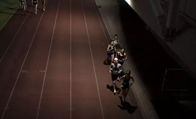 Beatie Deutsch, an Orthodox Jewish runner, second from bottom right, trains with her team in Tel Aviv, Israel, Wednesday, June 26, 2024. “Most people would see sports and religion as very separate, but I see a big overlap. Everything we have is a gift from God – He’s the one who’s given me this strength,” says Deutsch. (AP Photo/Maya Alleruzzo)