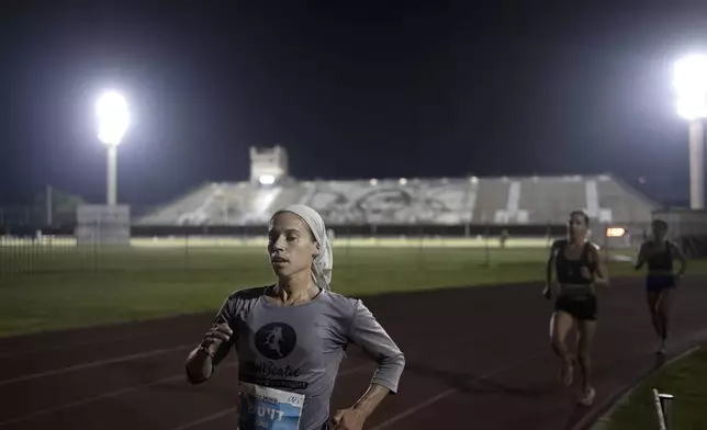 Beatie Deutsch, an Orthodox Jewish runner, trains in Tel Aviv, Israel, Wednesday, June 26, 2024. "I'd love governing bodies of sports to do more to accommodate religion," said the 34-year-old mother of five. She qualified to represent Israel in the 2020 Tokyo Olympics but didn't compete because the women's marathon was scheduled for a Saturday, when she observes shabbat. (AP Photo/Maya Alleruzzo)