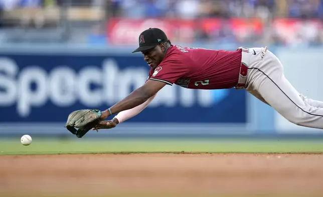Arizona Diamondbacks shortstop Geraldo Perdomo dives for a ball hit for a single by Los Angeles Dodgers' Andy Pages during the first inning of a baseball game Wednesday, July 3, 2024, in Los Angeles. (AP Photo/Mark J. Terrill)